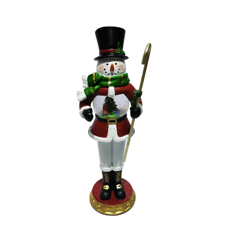 nutcracker statue with musical snow globe